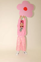Full length view of Dusty Star Pants in pink with yellow star print showing relaxed wide-leg fit