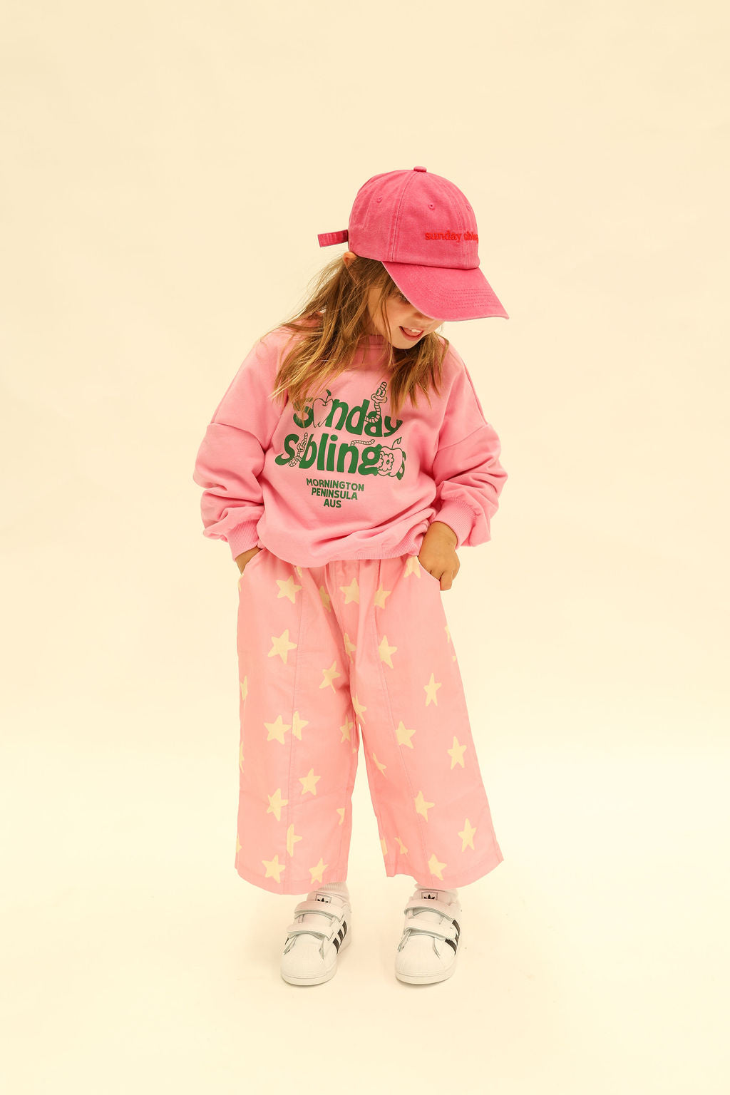 Detail shot of Dusty Star Pants showing elastic waistband and yellow star print on pink fabric