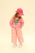 Detail shot of Dusty Star Pants showing elastic waistband and yellow star print on pink fabric