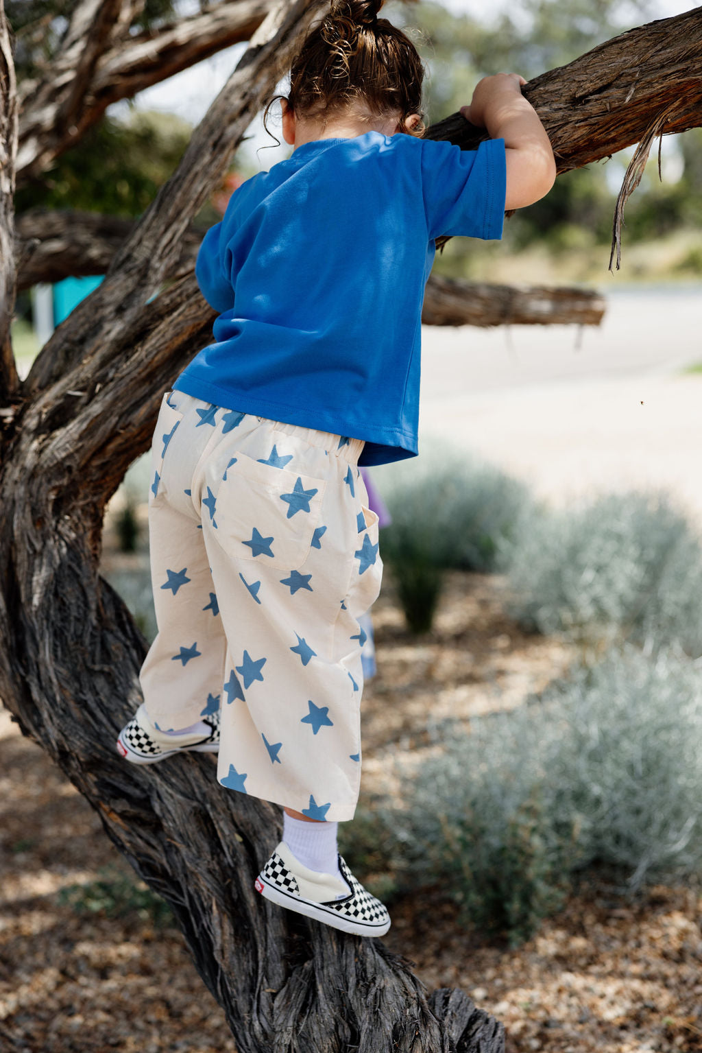 Girl climbing tree in Dusty Star Pants | Sunday Siblings