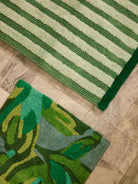 Close-up detail showing hand tufted cotton texture and floral pattern on Dutch Floral Green Bath Mat