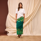 Profile view of model in Sage Clare Eliza Knit Maxi Skirt walking pose