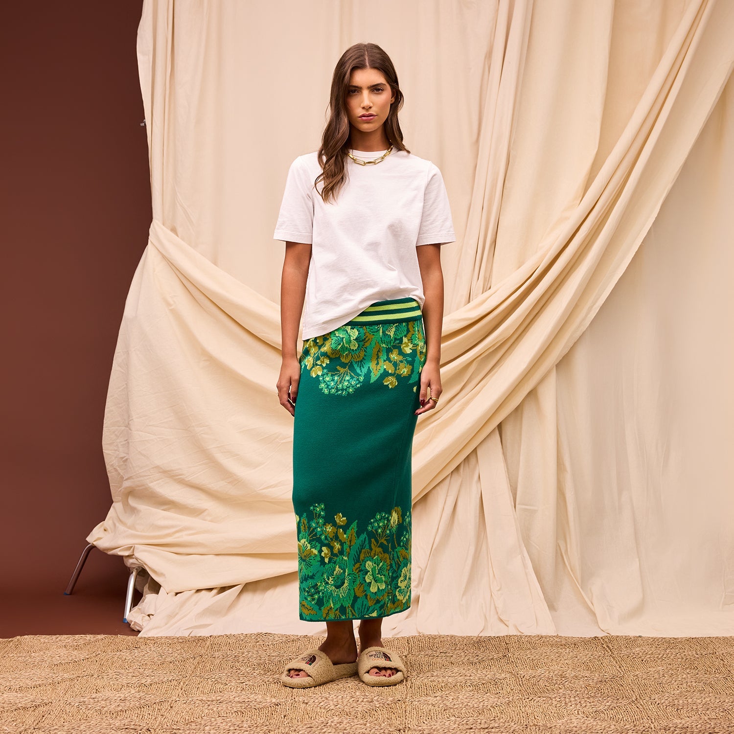 Profile view of model in Sage Clare Eliza Knit Maxi Skirt walking pose