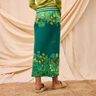 Back view of Eliza Knit Maxi Skirt displaying green floral motif and maxi length styling