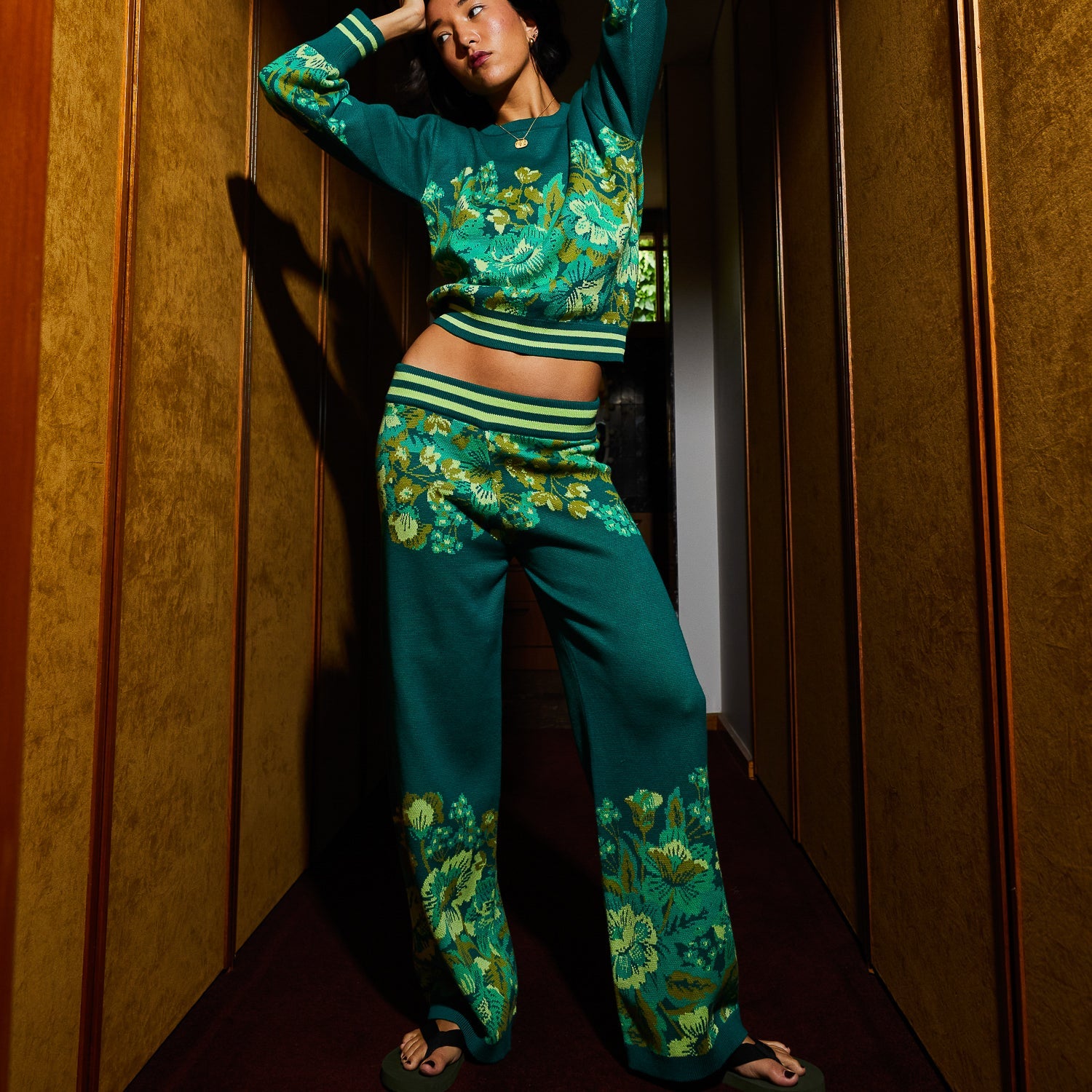 Full length view of Sage & Clare Eliza Knit Pants in green with yellow floral pattern and striped waistband