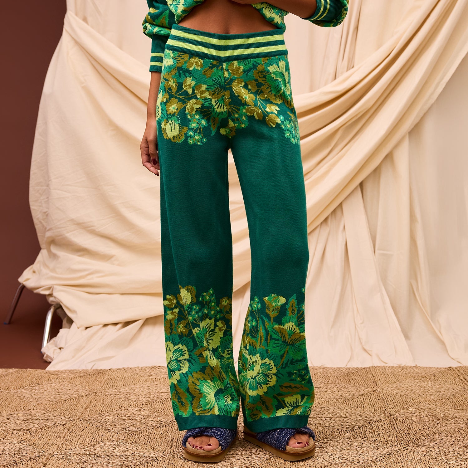 Close-up front view of Eliza Knit Pants showing striped waistband and floral knit pattern detail