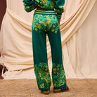 Back view of Sage & Clare Eliza Knit Pants showing full length silhouette and floral pattern on cream background