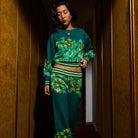 Full length view of Eliza Knit Sweater in teal with vibrant floral pattern and matching pants