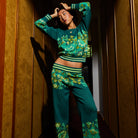 Model wearing Eliza Knit Sweater with arms raised showing fit and floral print design