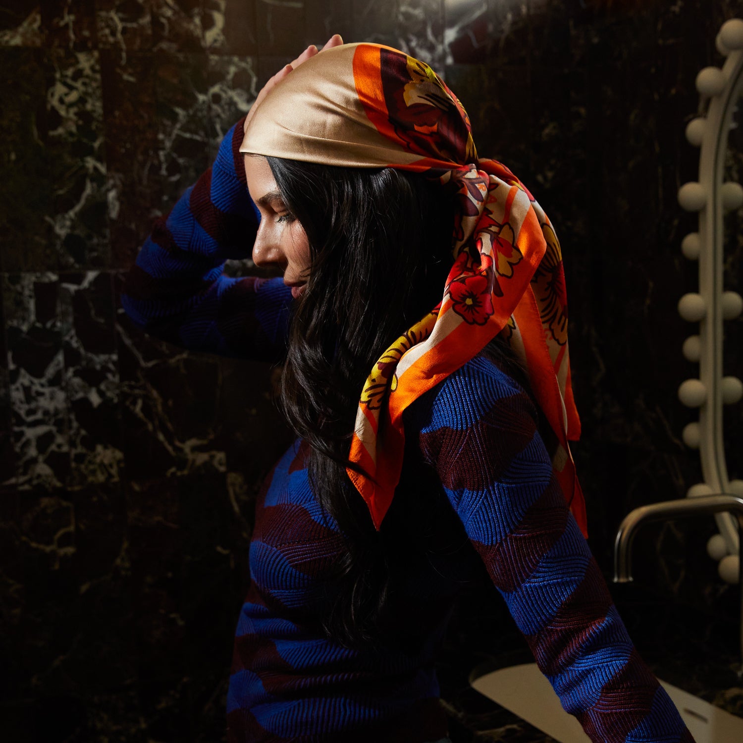 Side profile of model wearing Eliza Silk Scarf as elegant head covering with hair visible