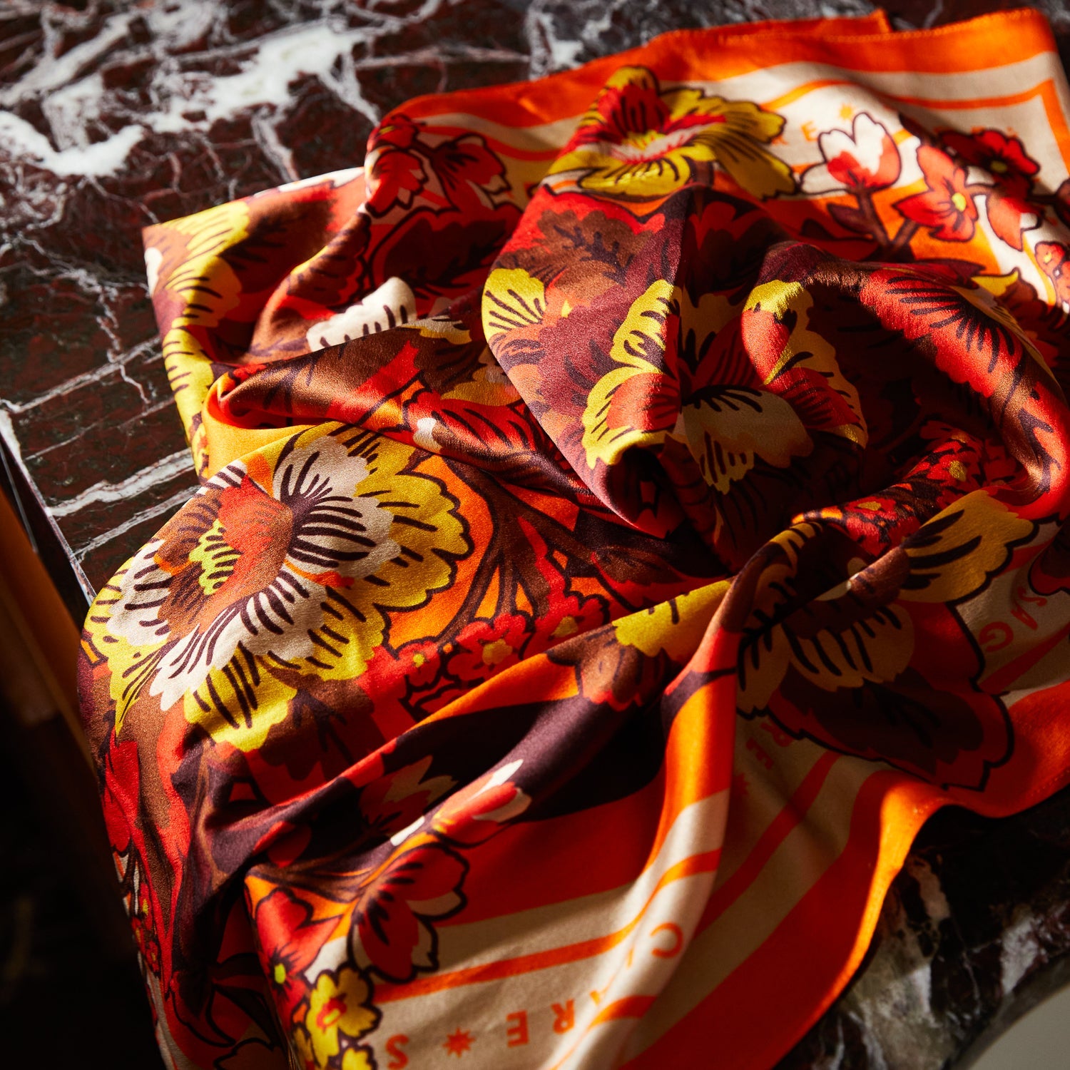Close-up detail of Eliza Silk Scarf fabric texture showing floral print and lustrous finish