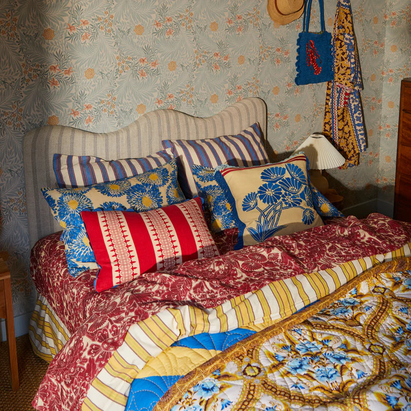 Emilia Embroidered Cushion by Sage & Clare displayed on bed