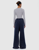 Back view of washed ink track pants showing elastic waistband and relaxed wide leg fit