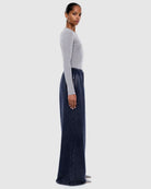 Profile view of washed ink track pants showing loose fit and elastic waistband detail