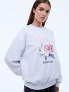 White marle oversized sweatshirt with feminine rose floral print and drop shoulder relaxed fit