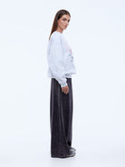 model wearing Ena Pelly Rose Sweatshirt styling shot showing crew neckline and rib cuff construction details