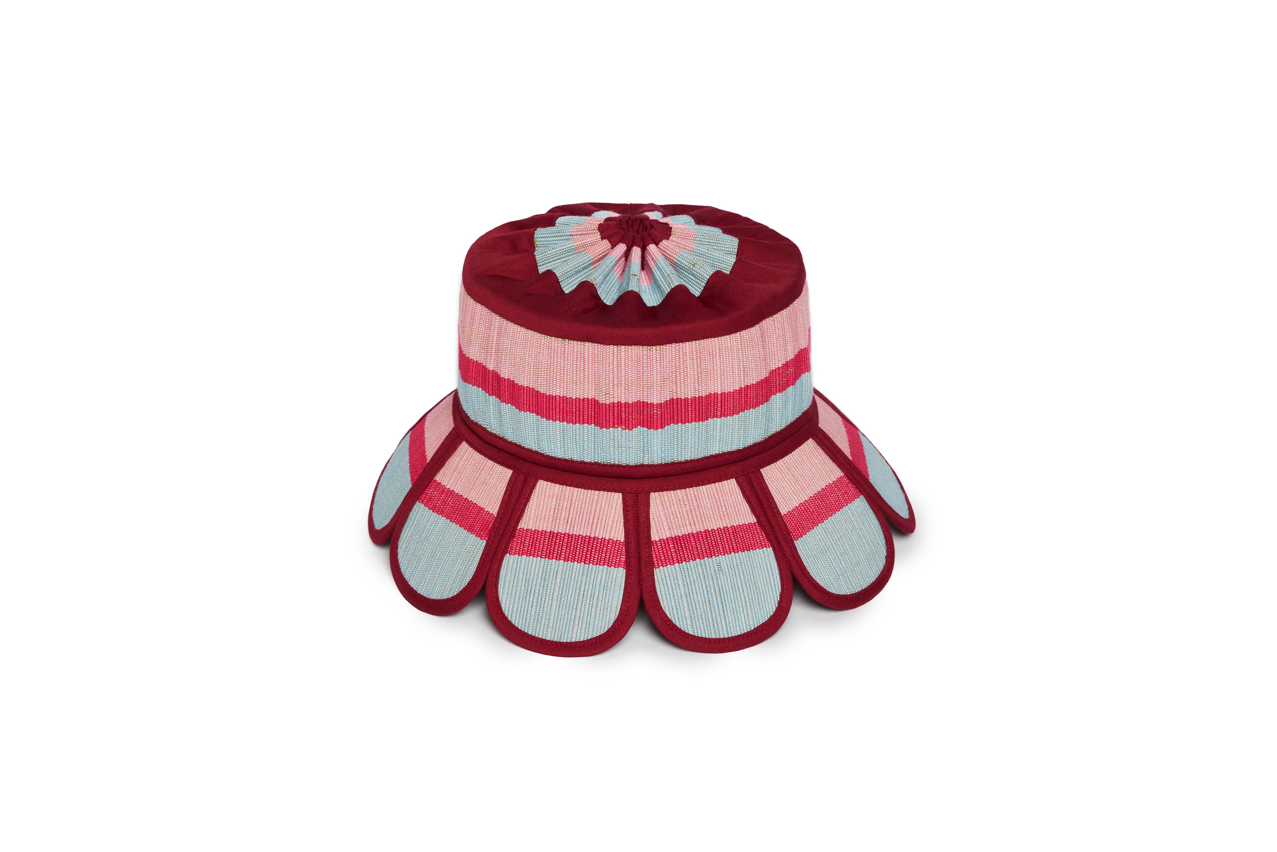 Flat lay view of Luxe Manhattan Hat showing scalloped brim design with burgundy pink and blue striped pattern