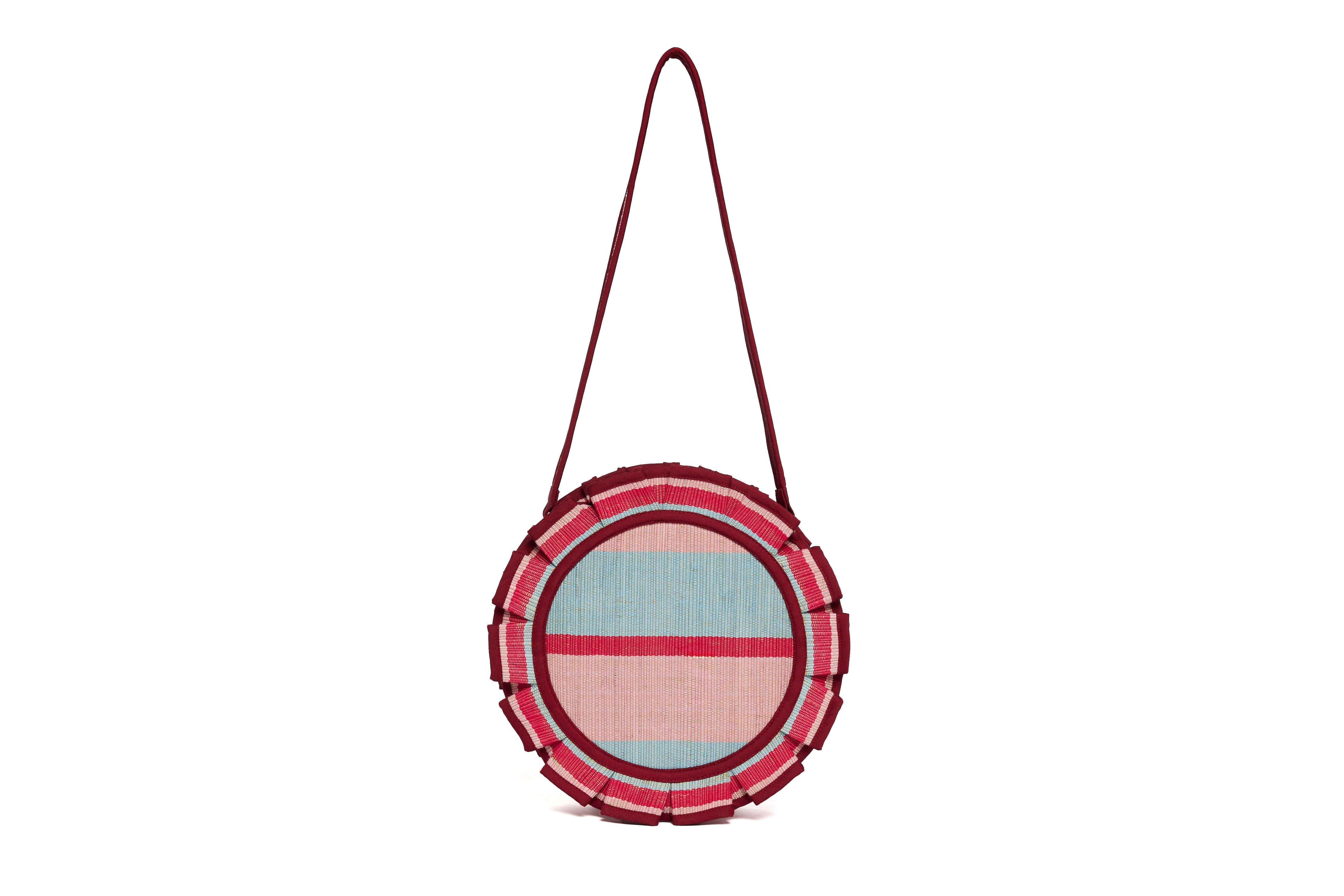 Front view of Escape Mini Love Note Tote featuring blue pink burgundy striped circular design with fringe trim