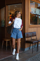 Model wearing indigo blue denim shorts by Ceres Life
