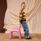 Side profile of child in Estrid Kids Cardigan showing relaxed drop shoulder fit and shaped sleeves