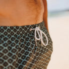 close up detail of man wearing Evergreen diamond swim shorts by Swim Shady