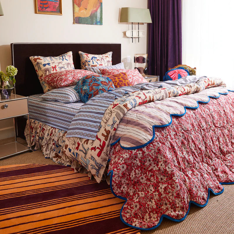 Evette Scalloped Quilted Coverlet by Sage and Clare - maroon and orange stripes on one side, red floral design on the opposing side. 
