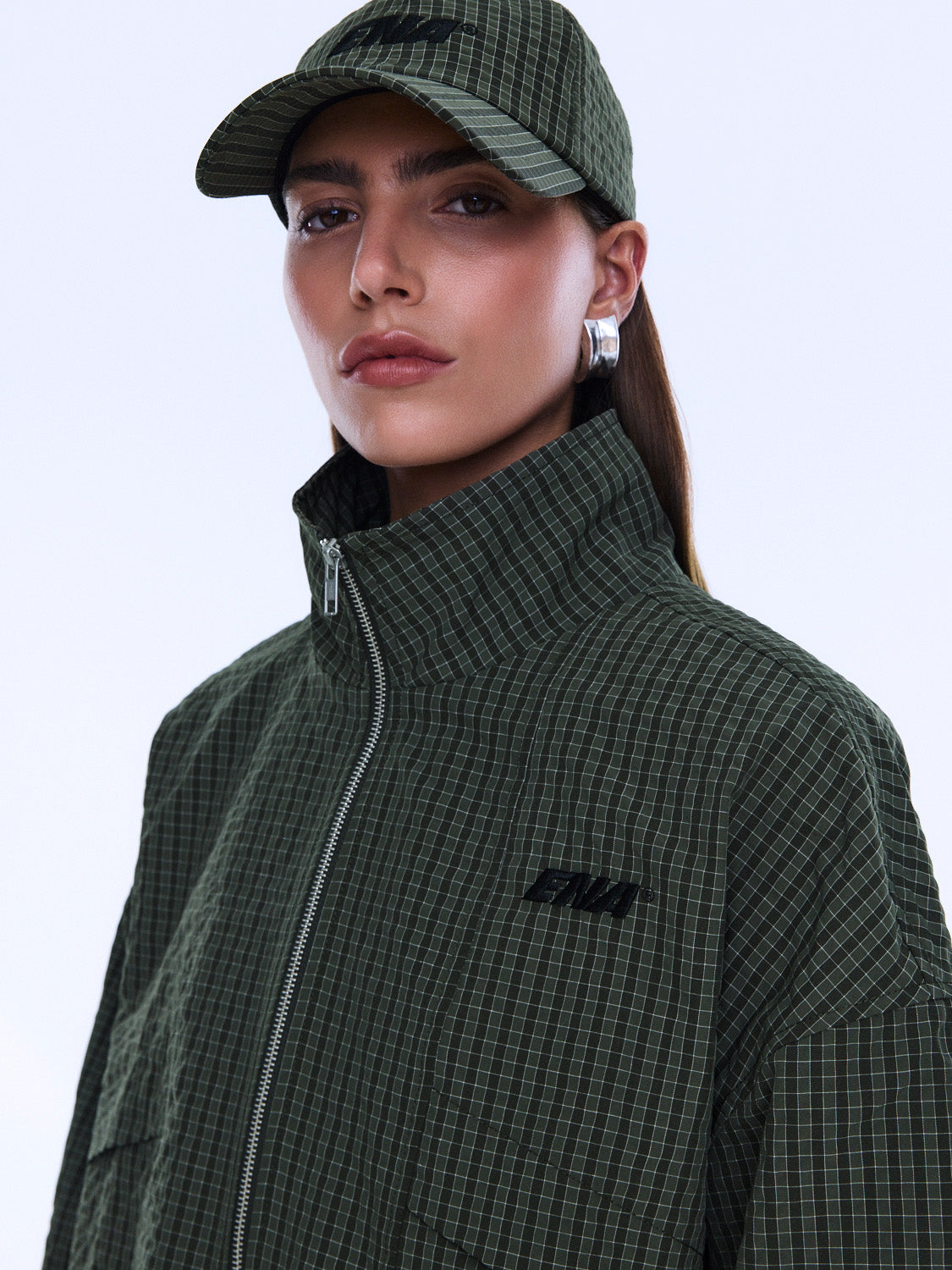 Close-up front view of Fallon Zip Thru Jacket showing olive check fabric texture and zipper detail