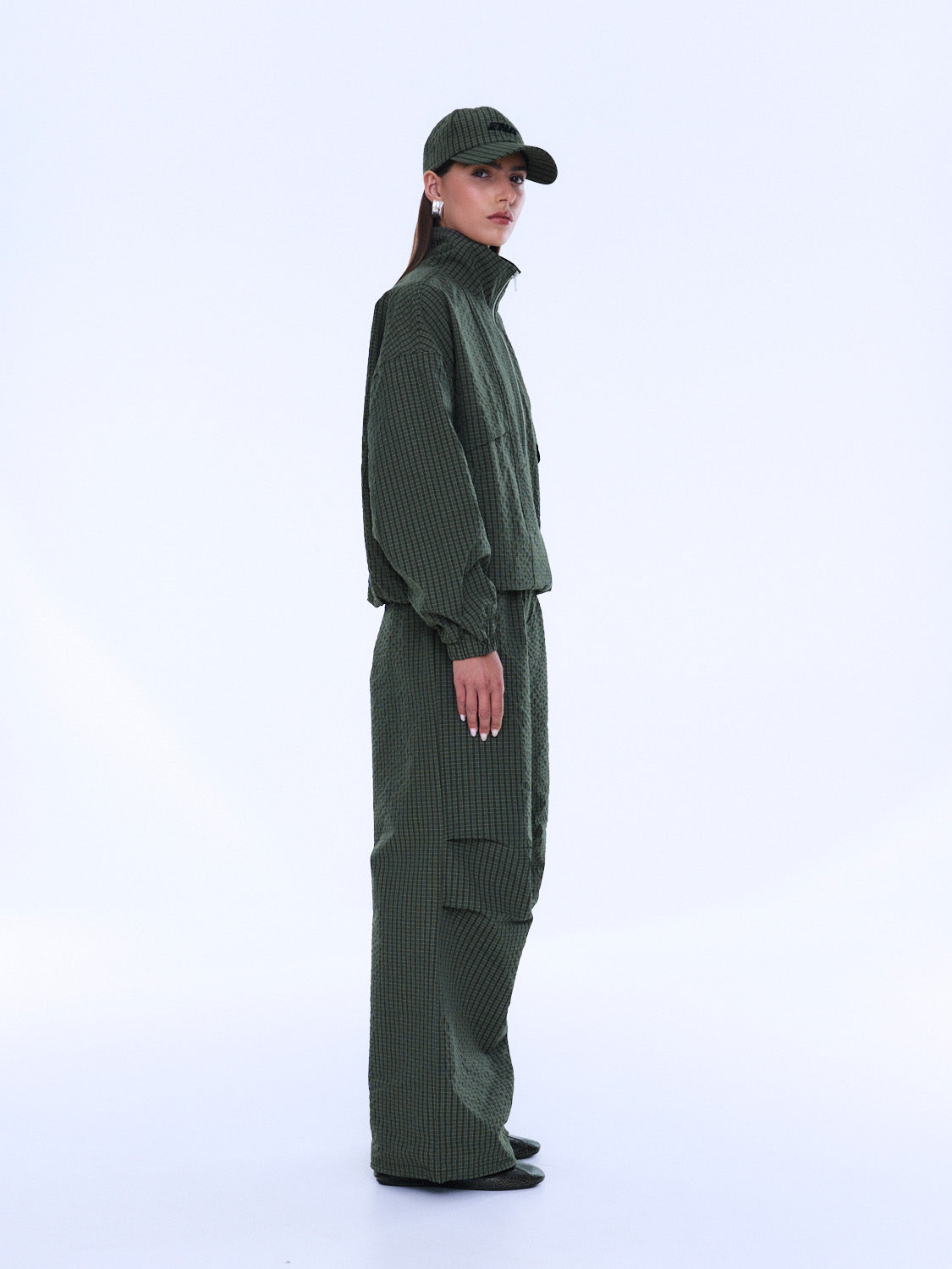 Side profile view of Fallon Zip Thru Jacket in olive check with structured silhouette