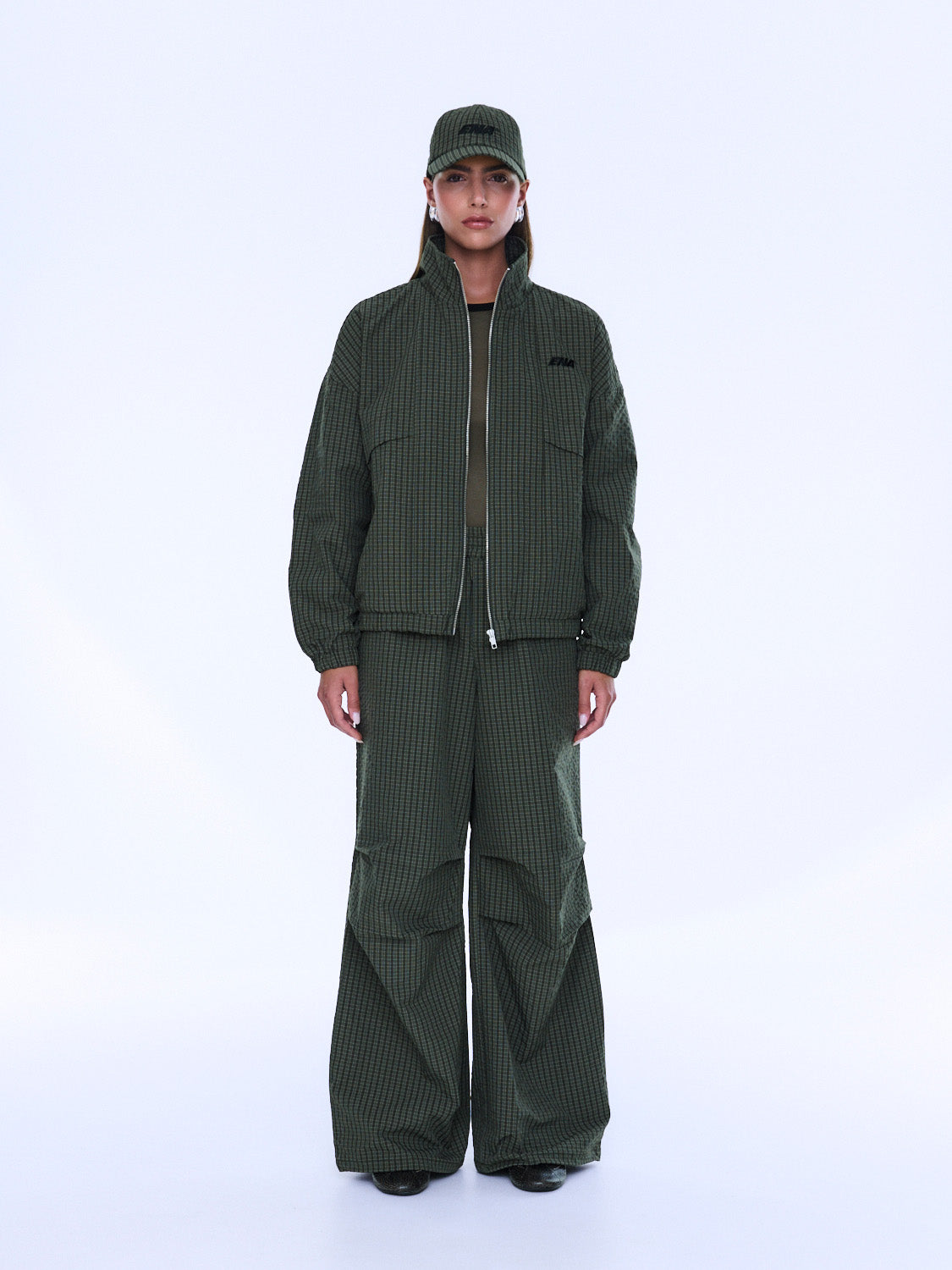 Front view of Fallon Zip Thru Jacket partially unzipped showing olive check pattern and fit