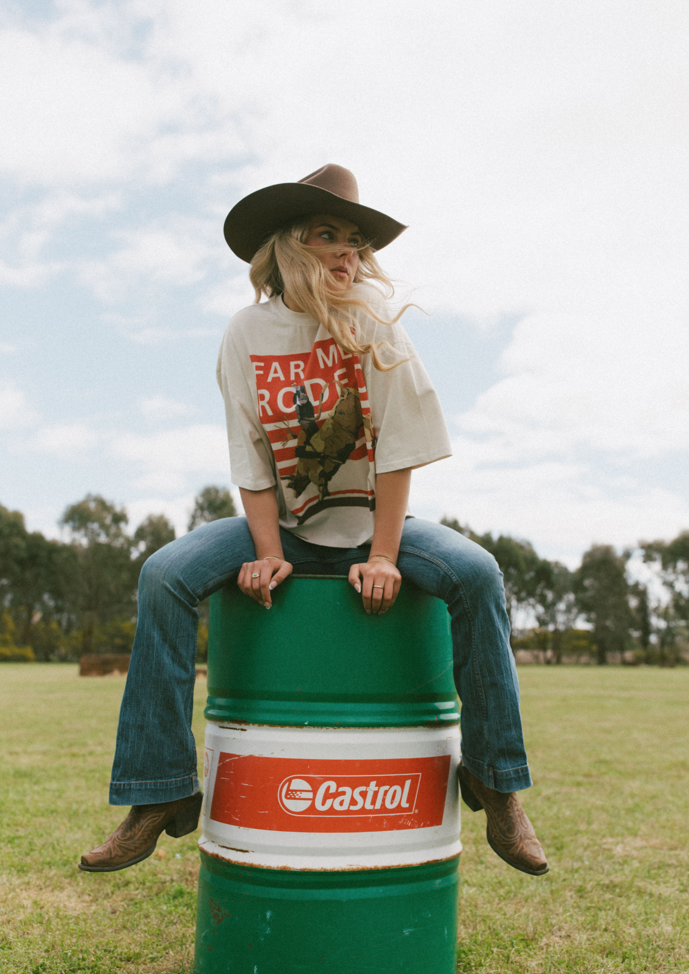 Back view of Rodeo Box Tee showing orange and white rodeo graphic with bull rider illustration