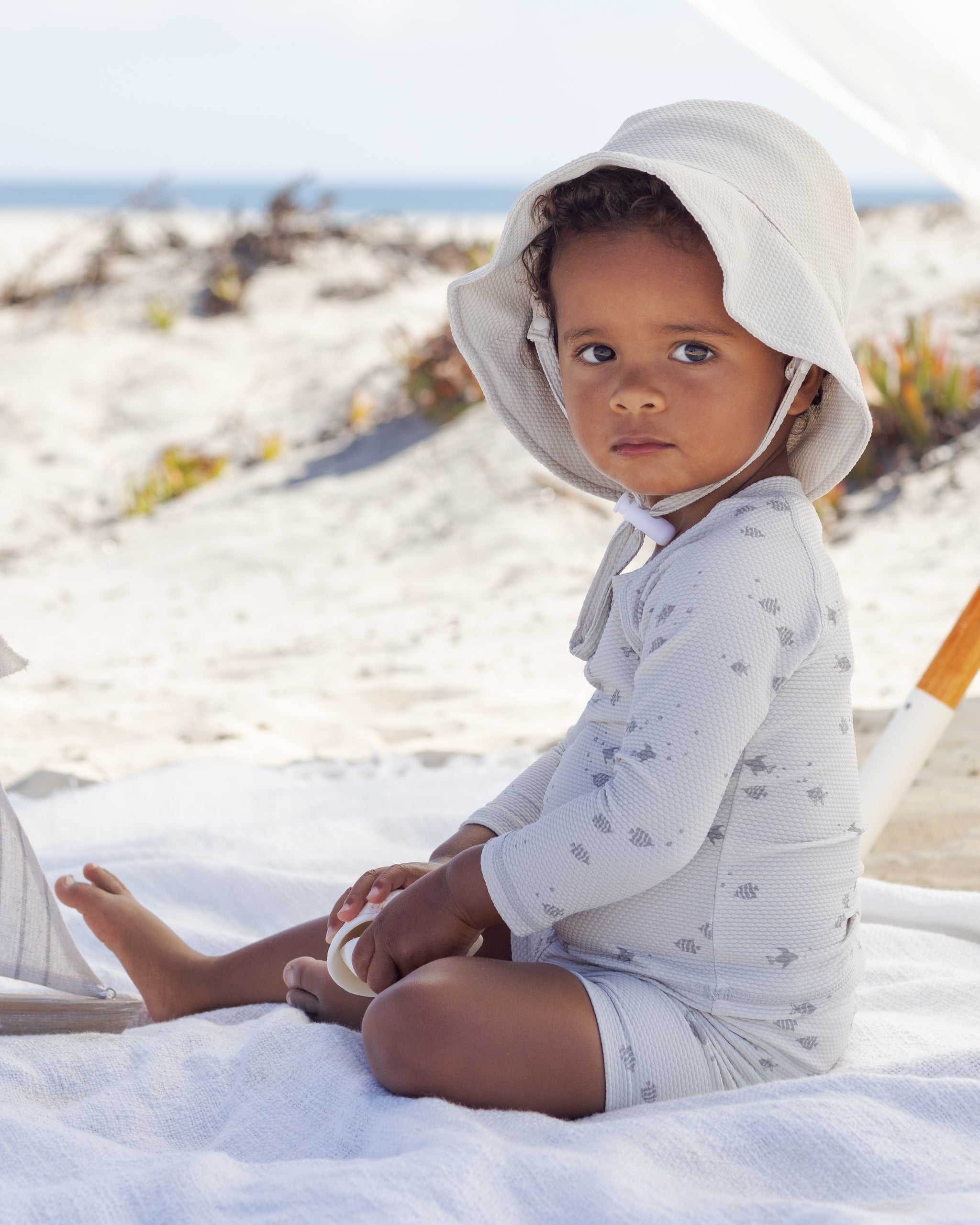 Boy in the Finn Rashguard + Short Set Fish | Quincy Mae at the beach