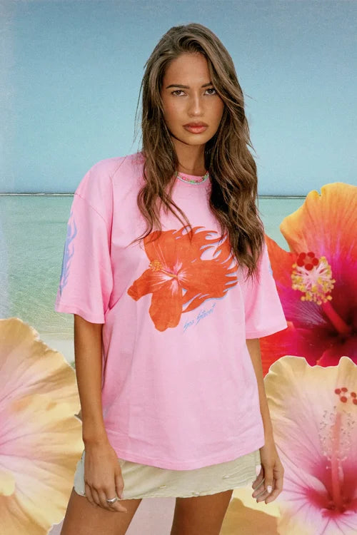 model wearing the 100% cotton pink Flaming Hibiscus T-Shirt by Sea Street