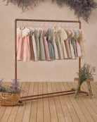Florence Dress Sky Stripe displayed on clothing rack with other Noralee vintage-inspired dresses