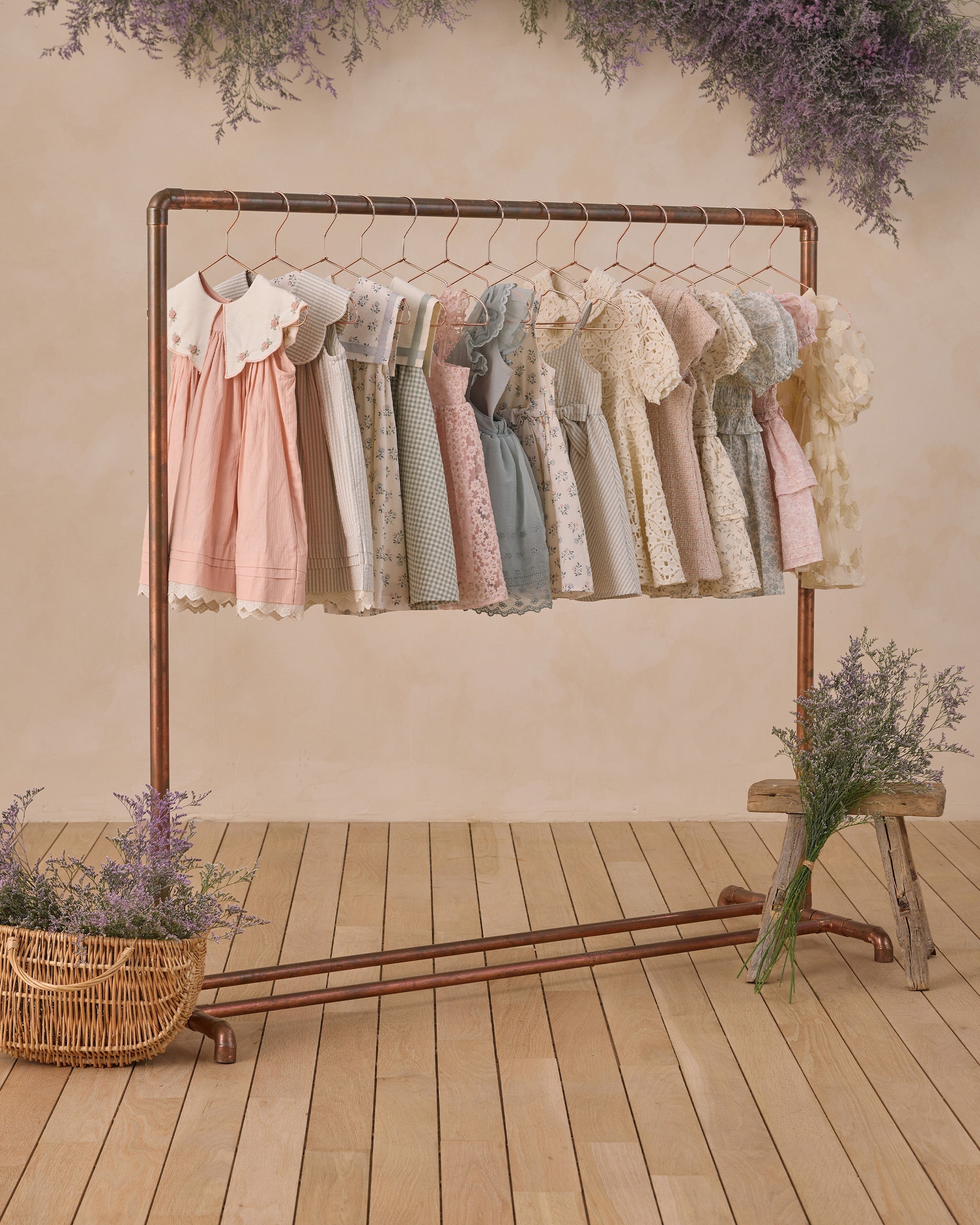 Florence Dress Sky Stripe displayed on clothing rack with other Noralee vintage-inspired dresses