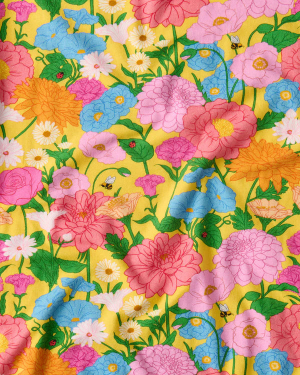 fabric details of Follow The Sun Yellow Organic Short Sleeve Frill Romper by Kip & Co