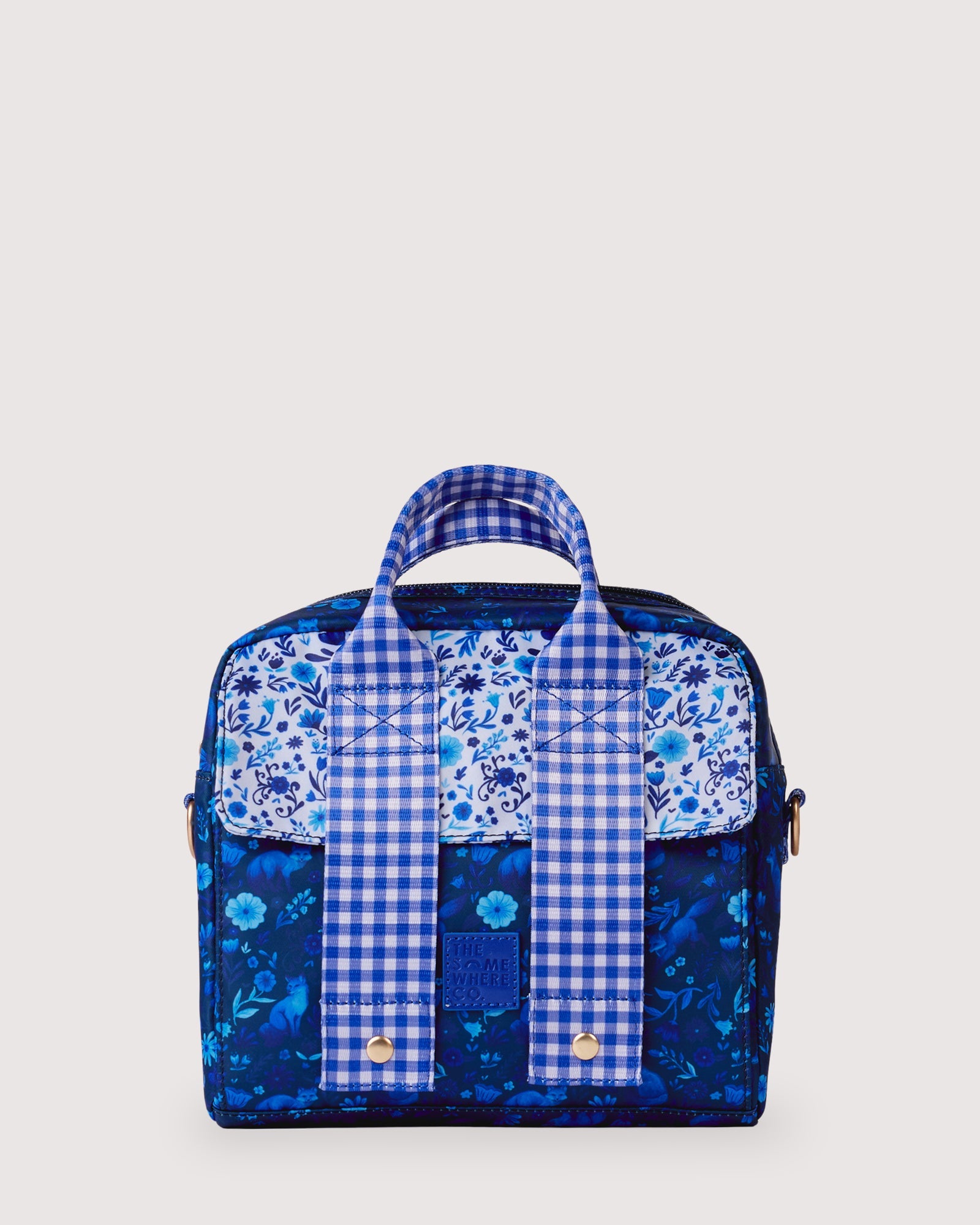 Close-up of blue gingham adjustable shoulder strap with gold hardware and buckle detail
