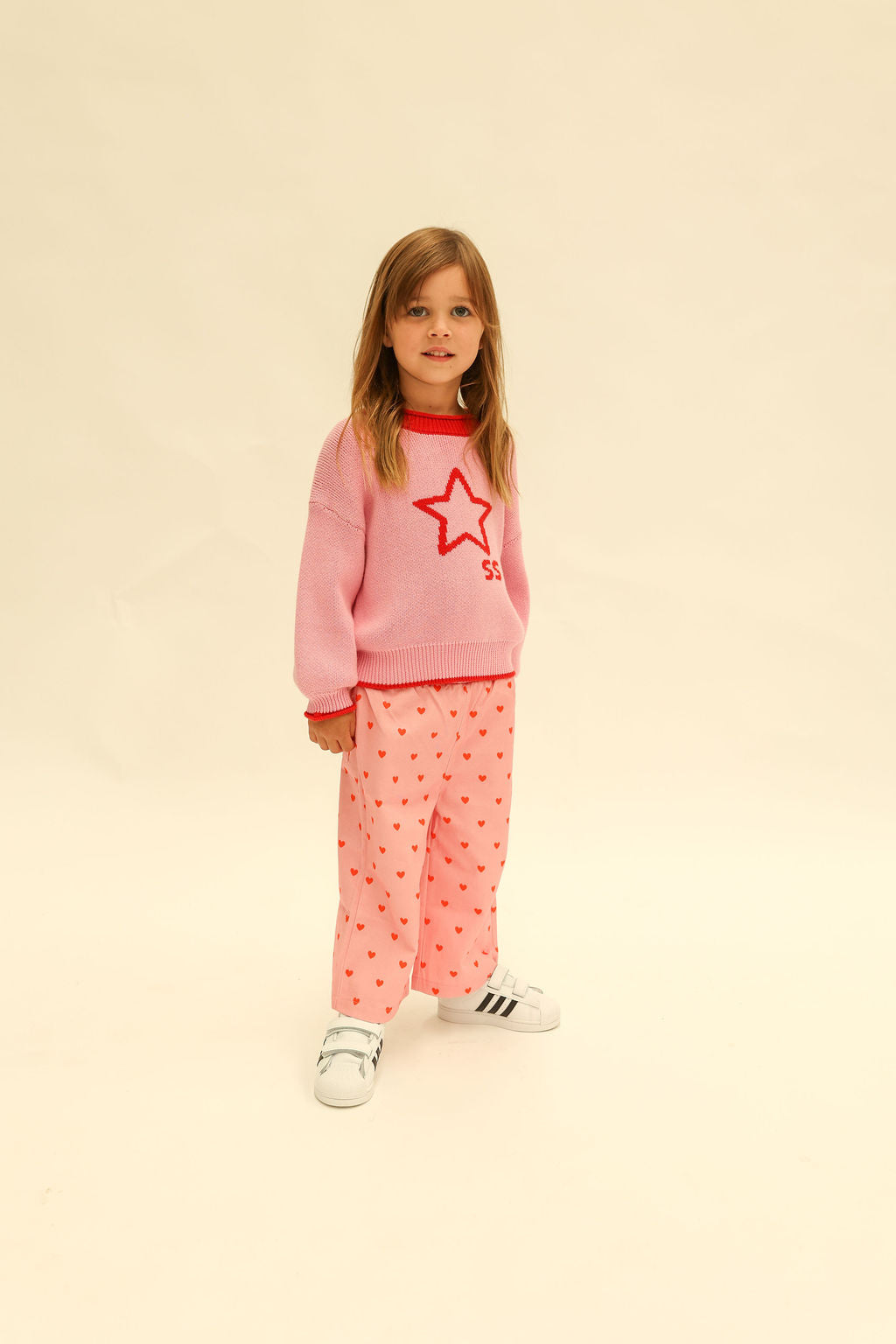 Front view of pink heart print Fruit Loop Pants showing elastic waist and relaxed fit
