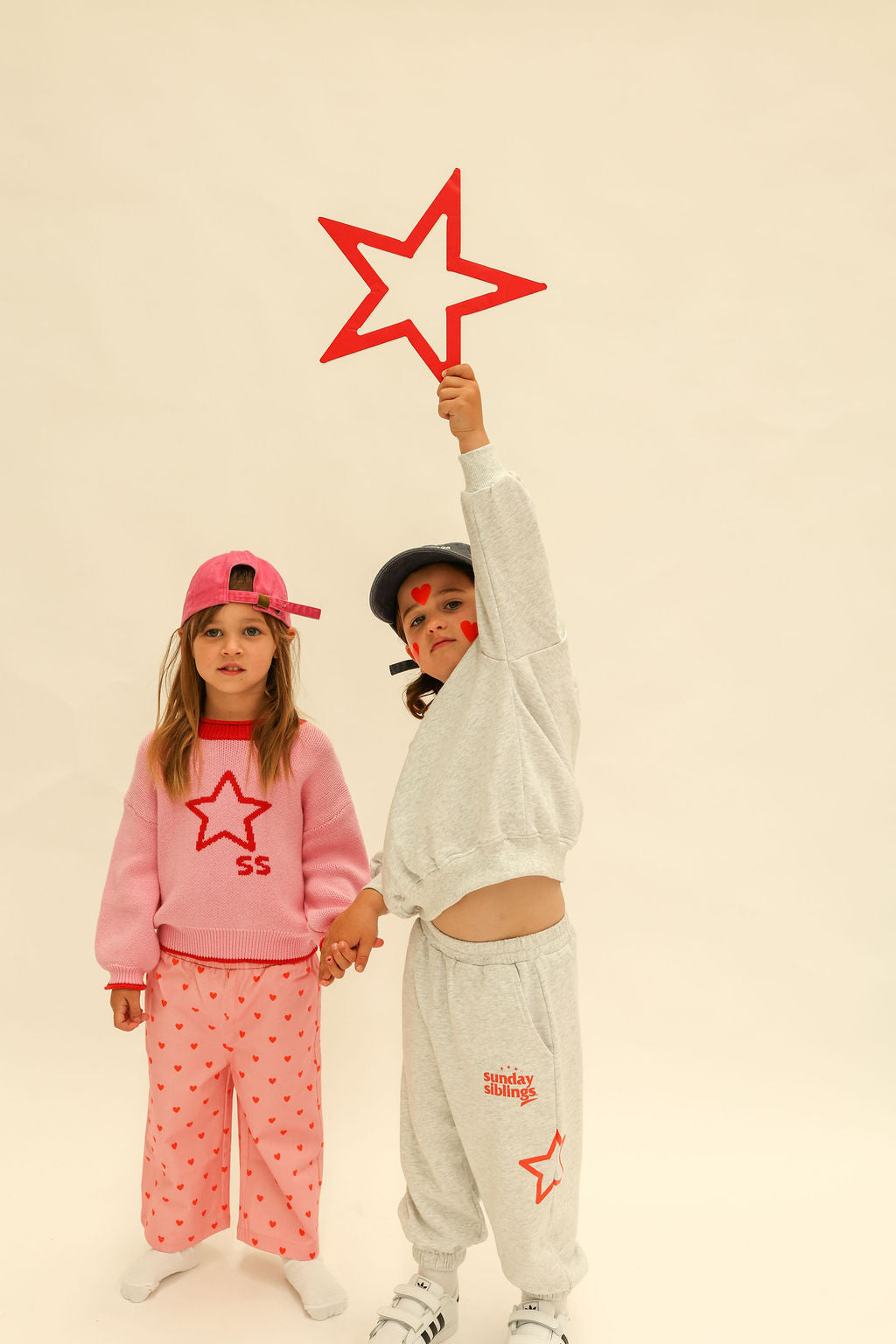 Side angle of pink heart printed Fruit Loop Pants displaying wide leg cut and comfortable styling