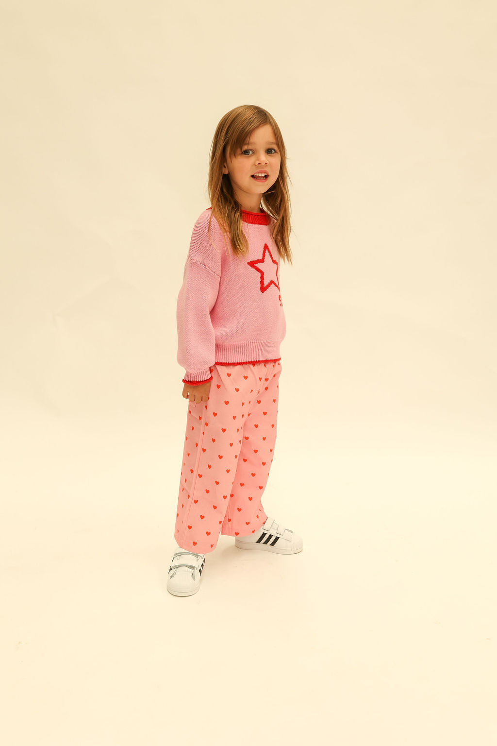Three quarter view of pink Fruit Loop Pants Hearts showing heart pattern and loose comfortable fit
