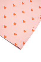 Macro detail shot of red heart print pattern on pink Fruit Loop Pants fabric