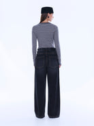 Back view of Georgia Denim Jean showcasing rear pockets and wide leg shape in dark wash denim
