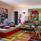 Colorful living room with a sectional sofa, coffee table, and decorative Sage & Clare pillows.