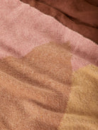 Detail view of mohair fabric texture showing pink and brown geometric pattern