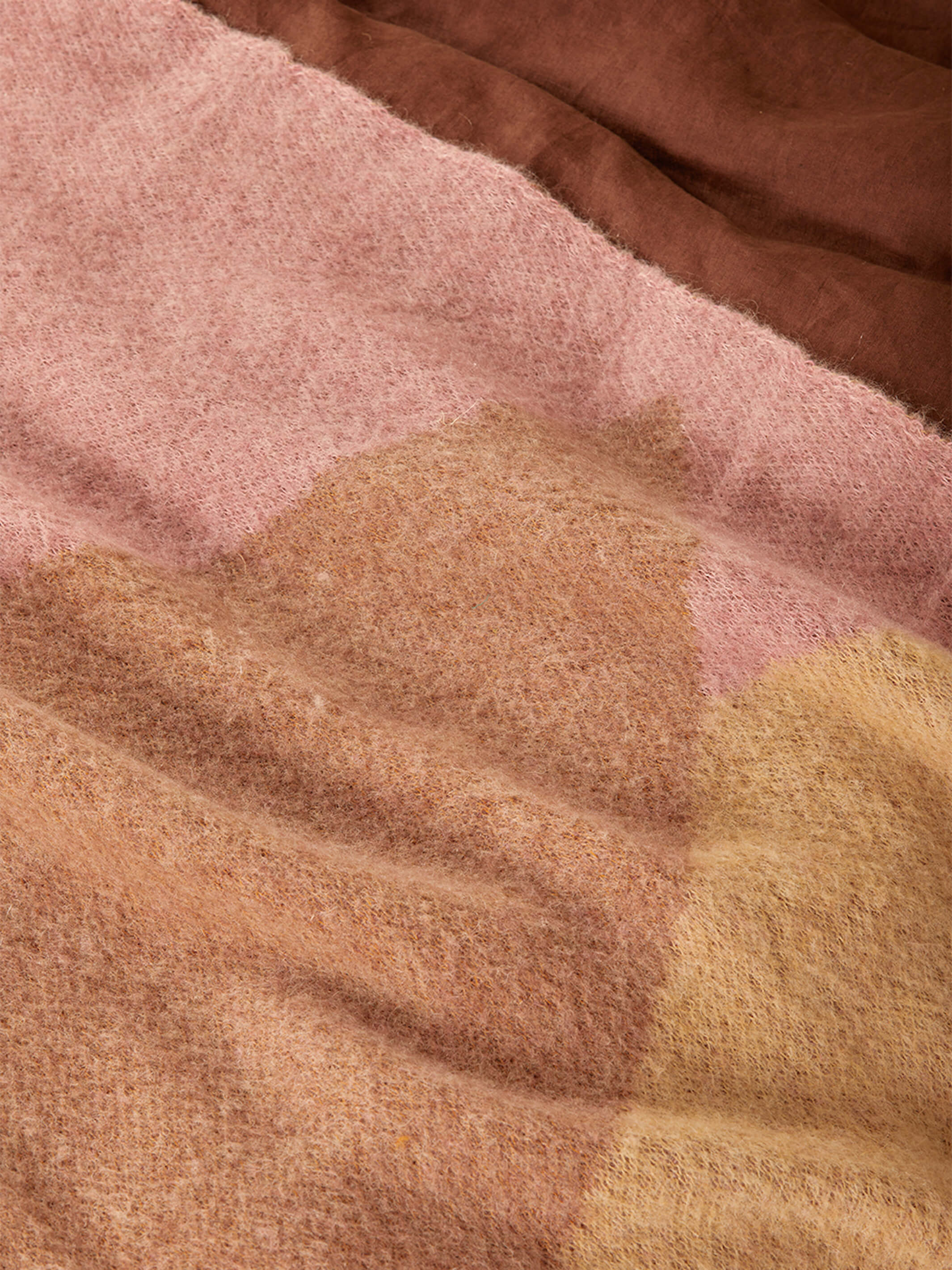 Detail view of mohair fabric texture showing pink and brown geometric pattern