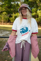 Outdoor modeling shot of Get Barrelled Artist Ringer Tee by Ty Williams showing full front design