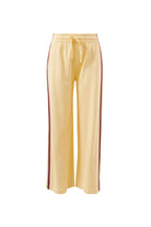 Front view of butter yellow wide leg track pants with burgundy side stripe and elastic waistband
