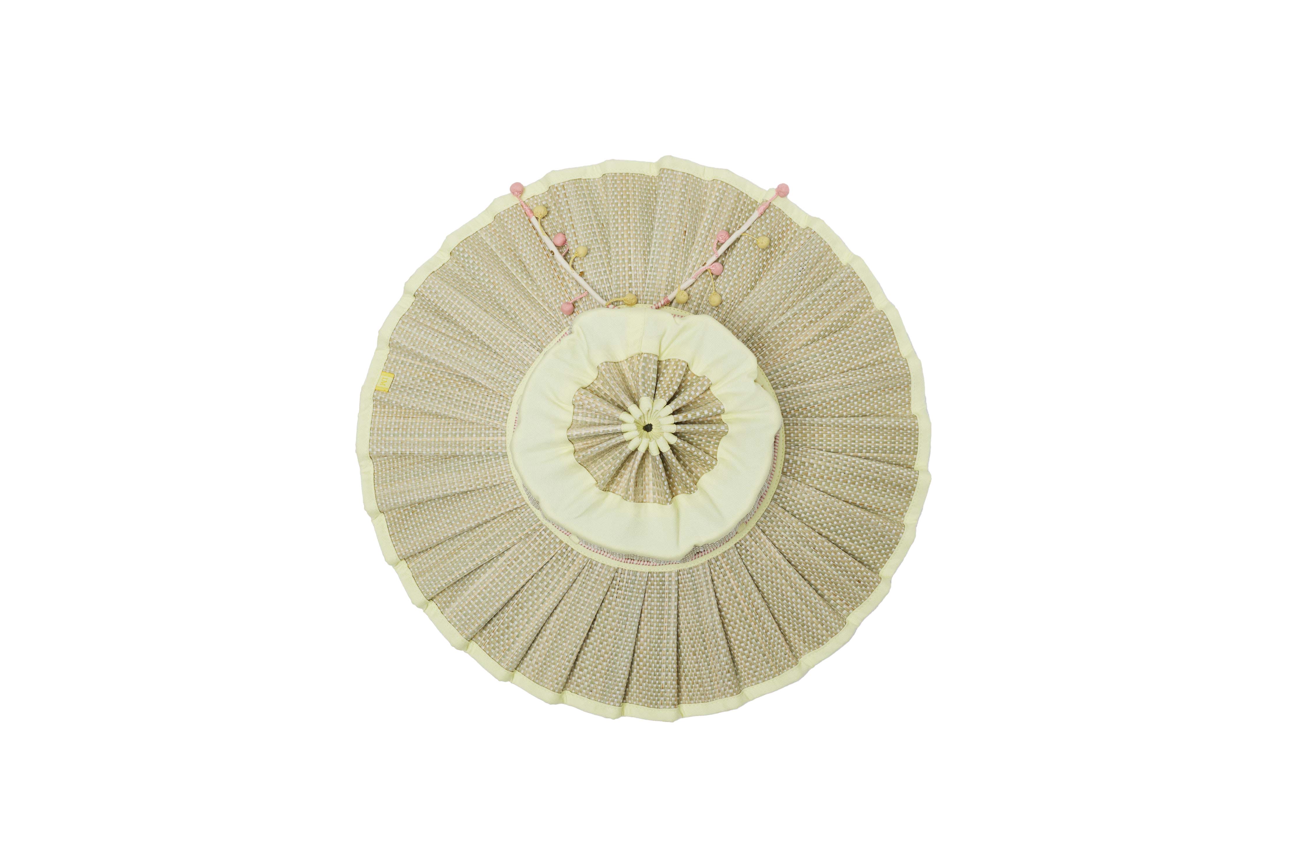 Flat lay top view of Lorna Murray Godesis Capri Play hat showing radial pleating pattern and adjustable chin ties