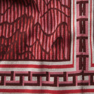 Extreme close-up of knit fabric texture showing intricate geometric pattern and border detail