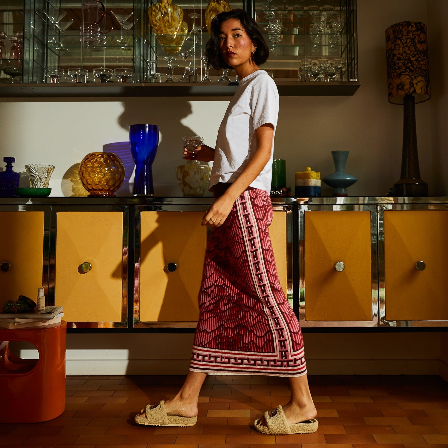 Profile view of model in Sage Clare Hanna Knit Maxi Skirt demonstrating movement and drape