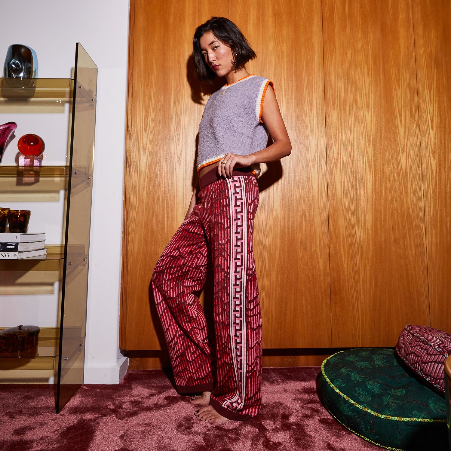 Side view of red textured Hanna knit pants with Greek key stripe and wide leg silhouette